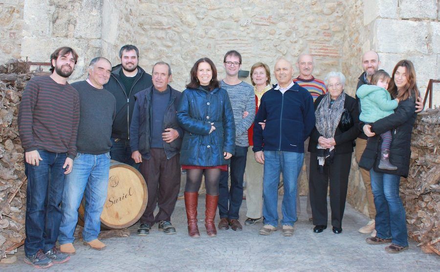 Azimut team standing outdoors, posed near a stone wall and a barrel.