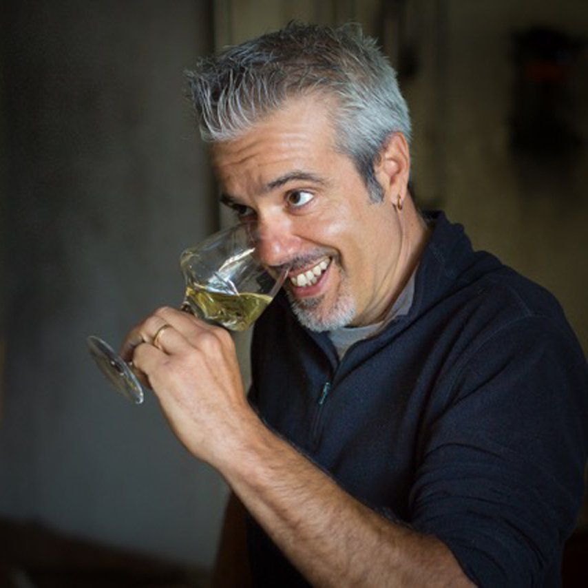 Winemaker of Cave de Cairanne smiling while tasting wine