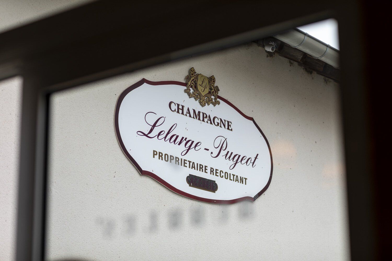 A sign that says champagne Lelarge-Pugeot on it