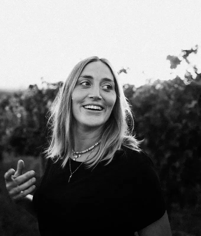 Winemaker of Cordero San Giorgio standing in a vineyard, smiling.