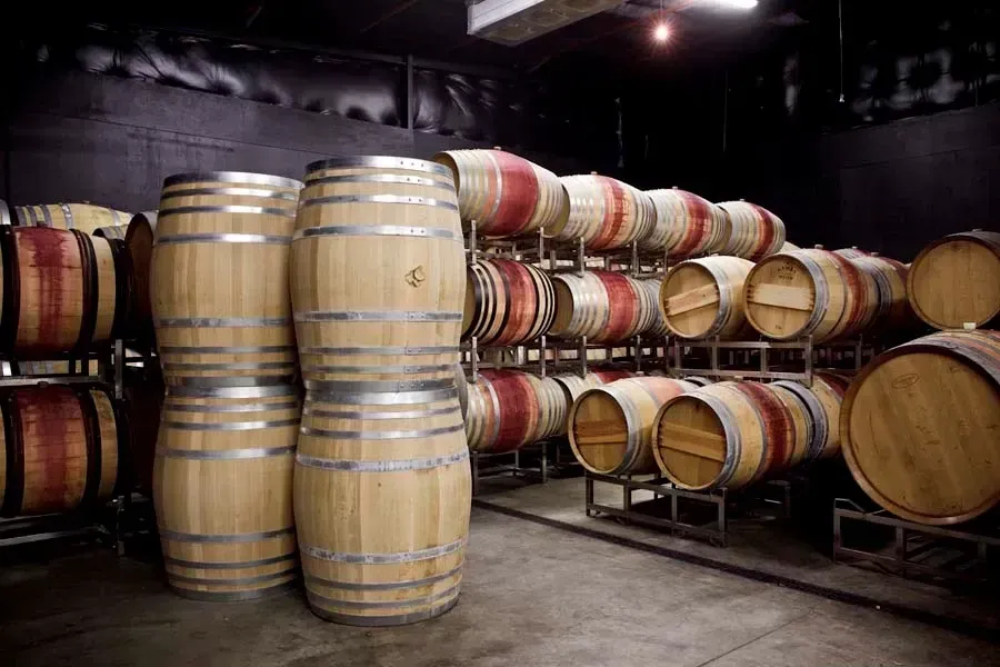 Wooden barrels stacked and stored in Sandhi wine cellar